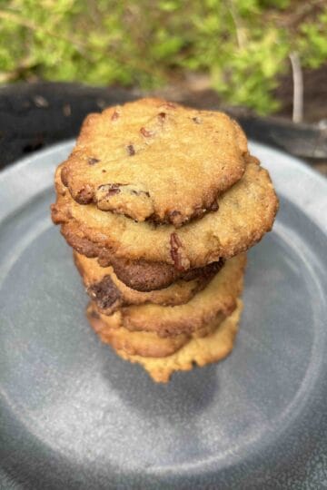 thin and crispy chocolate chip cookies in a stack